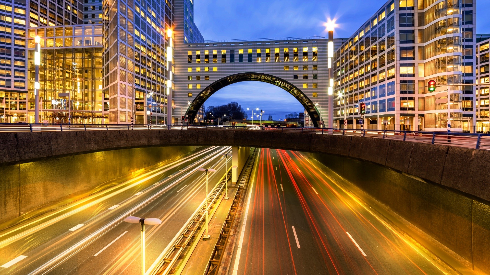 Photo of an overpass with modern office buildings built on top.